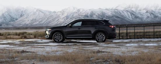 Image of a Mazda CX-9 SUV in front of a mountainous backdrop.
