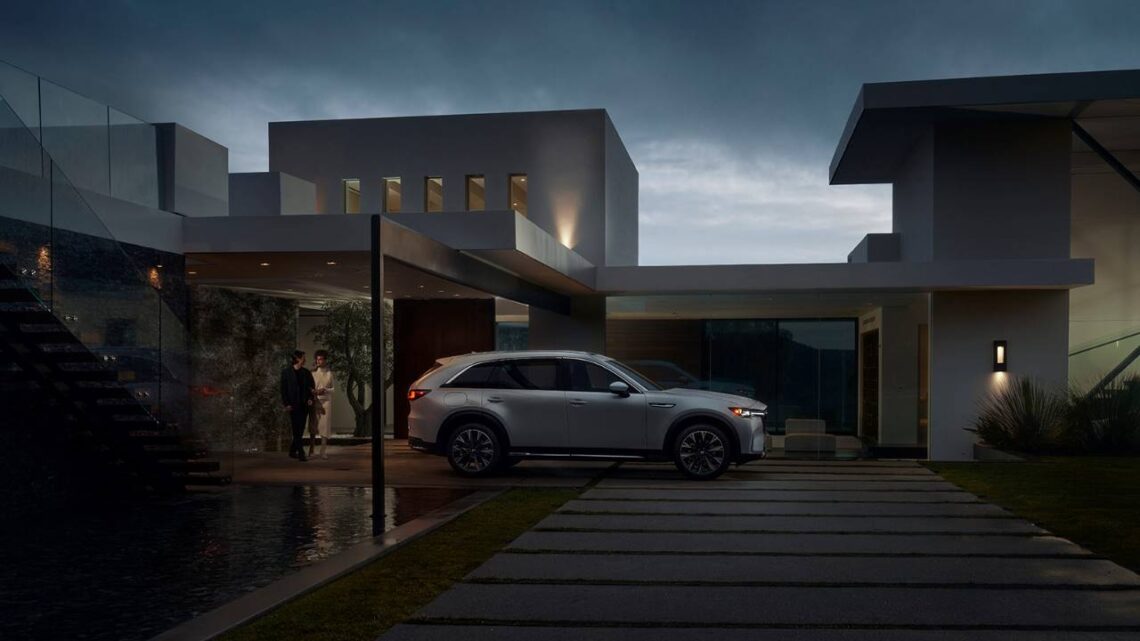 A Mazda PHEV charging in a driveway