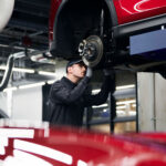 Mazda service technician working on brakes