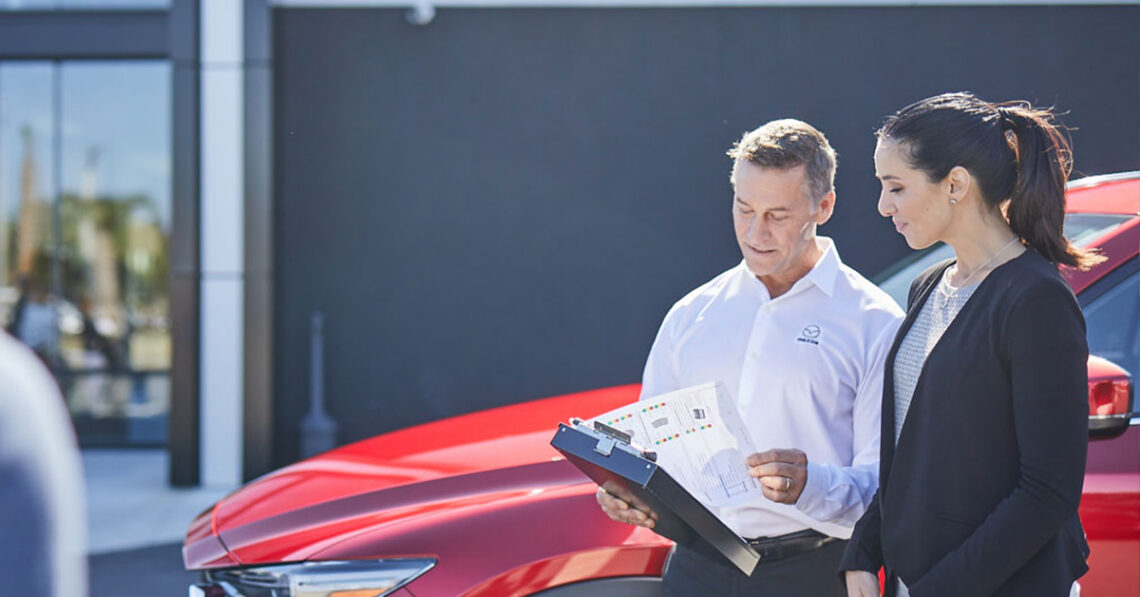 Mazda service customer speaking with a service tech