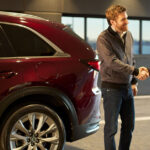 Mazda recall service technician shaking hands with a customer